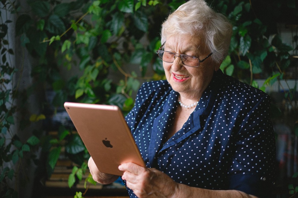 A grandmother smiling at her tablet